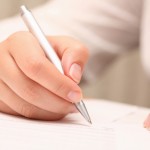 woman-signing-contract via sheknows.com
